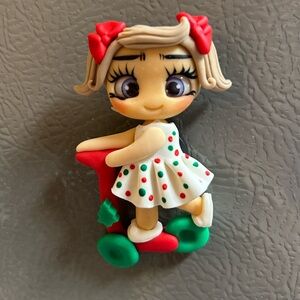 Clay doll in a scooter